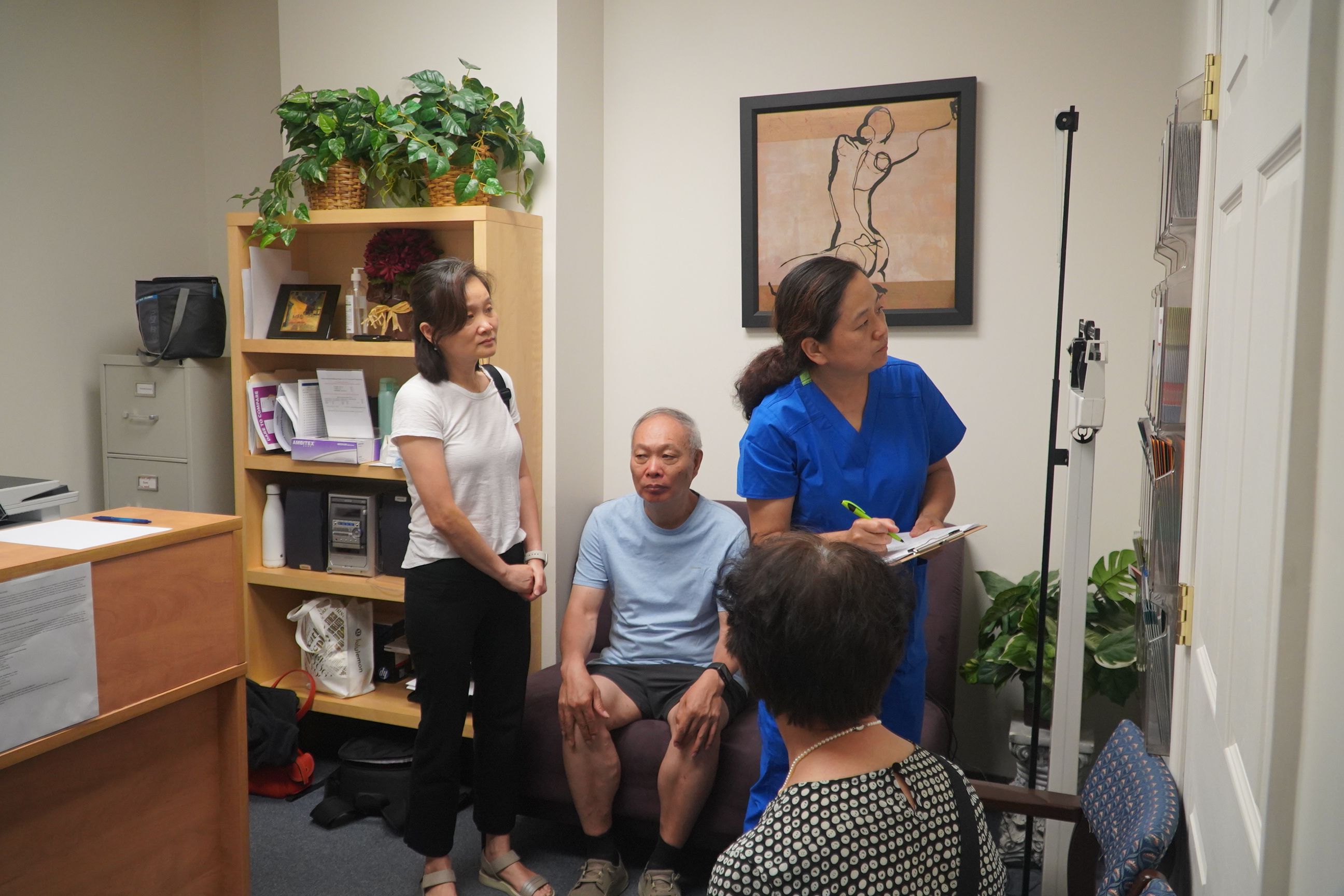 A volunteer at Asian American Healthcare Center is taking notes for patients. (Photo by: Pingping Yin)